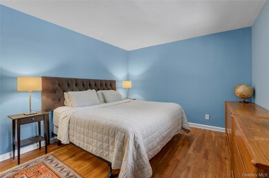Bedroom with wood finished floors and baseboards