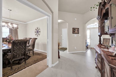 Upon entry to the home, there are two secondary bedrooms to the left and the utility room/garage access to the right.