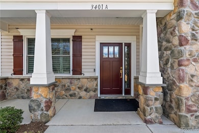 Entrance to property with stone siding and covered