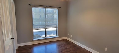 Spare room with dark hardwood / wood-style floorin