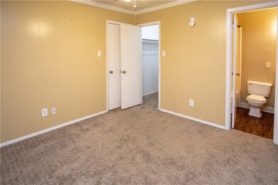 Unfurnished bedroom featuring crown molding, carpe