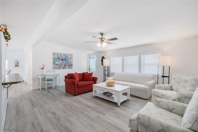 Living room with ceiling fan and light hardwood /