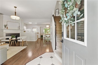 Foyer with a fireplace, light wood-type flooring, 