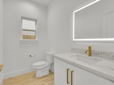 Bathroom with hardwood / wood-style floors, vanity