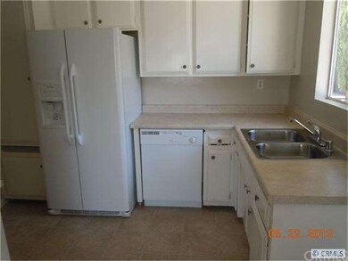 Kitchen with new countertops, sink, refrigerator