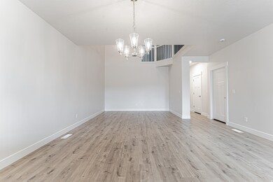 Spare room featuring light wood-style floors and a chandelier