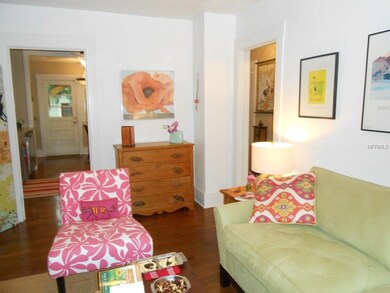 Living room has high ceilings and original hardwood floors.
