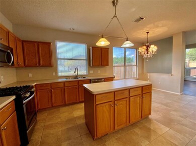 Large open kitchen with island.  Gas stove and built in microwave.