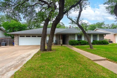Ranch-style house with a garage, driveway, roof w