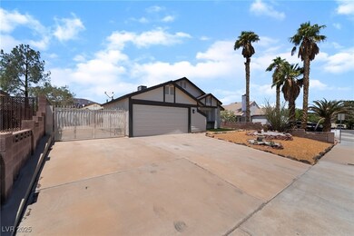 View of front of home featuring driveway, an attac