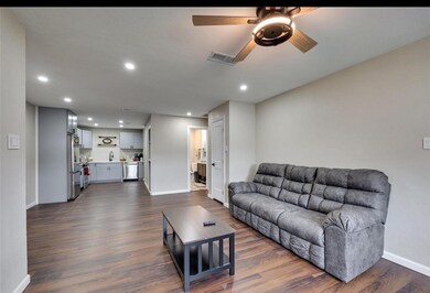 Living room featuring recessed lighting, dark wood-style floors, and a ceiling fan