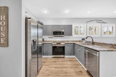 Kitchen featuring sink, gray cabinets, stainless s