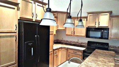 Custom kitchen features maple cabinetry.