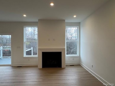 Unfurnished living room featuring light wood-style floors, a fireplace, and recessed lighting