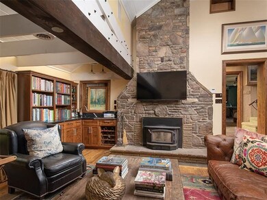 Great room with wood burner and wet bar to the lef