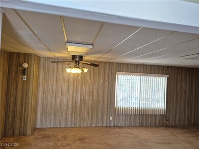 Carpeted spare room featuring wooden walls and cei