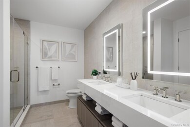Bathroom featuring double vanity and a stall shower