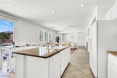Kitchen with white appliances, light tile patterne
