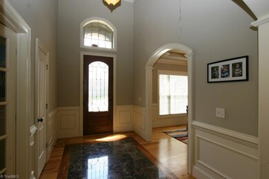 2 Story Entry with marble and hardwood. Gorgeous woodwork, heavy moldings and archway.