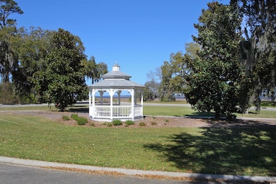 Surrounding community featuring a gazebo and a lawn