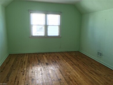 Second floor bedroom with beautiful hardwood floor.