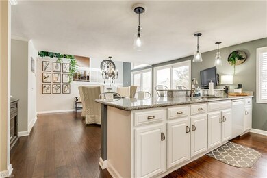 Kitchen with white cabinets, hard wood floors, gra