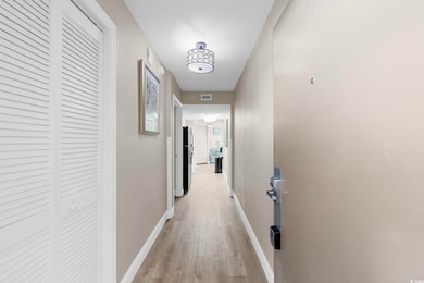 Hall featuring baseboards and light wood-type flooring