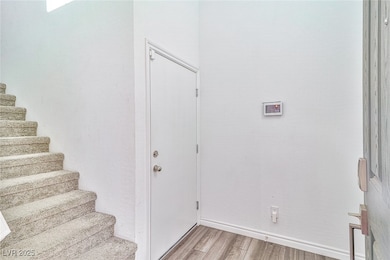 Entrance foyer featuring light wood finished floors and stairway