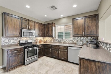 Kitchen with stainless steel appliances, a sink, d