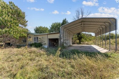 View of parking / parking lot featuring a carport