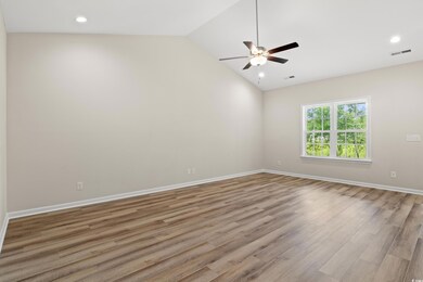 Spare room with vaulted ceiling, ceiling fan, and 