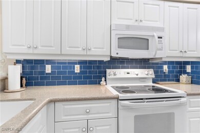 Kitchen with white appliances, quartz countertops,