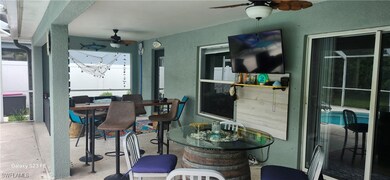 Dining space with a ceiling fan and a textured wal