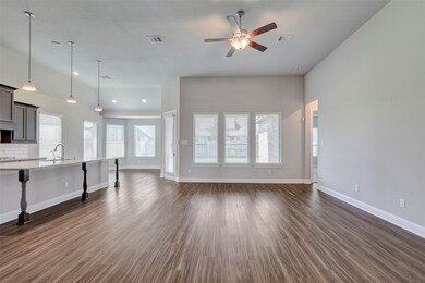 Spacious, open-concept living area with wood floor
