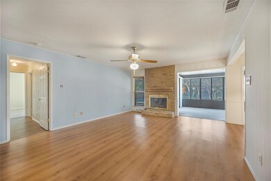 Unfurnished living room featuring ceiling fan, a f