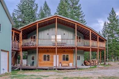 Rear view of property featuring a porch, board and batten siding, and a garage