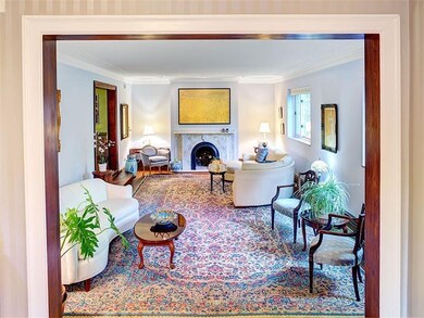 Sunken living room boasts a large marble gas log f