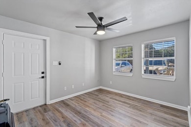 Unfurnished room featuring a ceiling fan, a textu
