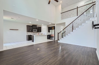 Unfurnished living room with ceiling fan, light w