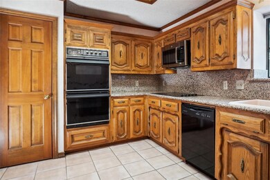 Kitchen featuring granite, black appliances, moldi