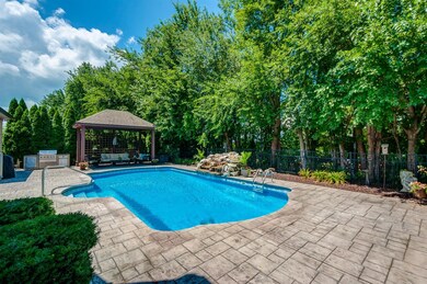 NO WAITING for your pool to be installed, as this home features a Heated Saltwater Pool with an AMAZING water feature, outdoor kitchen area, and Pergola. 