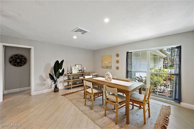 Dining space with light wood finished floors and recessed lighting