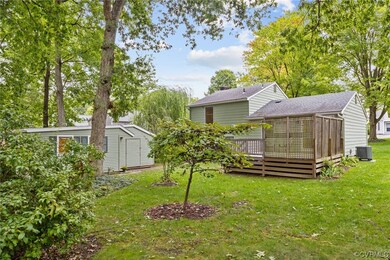 View of yard with central AC unit and a deck