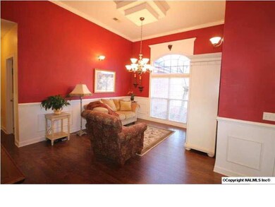 The Dining Room is currently being used as a sitting room- extra high and unique ceiling, wainscoting and great architectural details over the window.