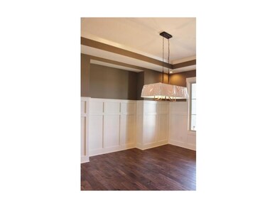 Formal dining room with wainscoting and hardwood f