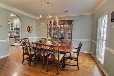 Dining space with ornamental molding, a chandelier