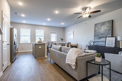 Living room with dark hardwood / wood-style floors and ceiling fan