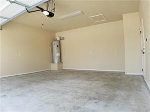 Garage featuring strapped water heater and baseboards