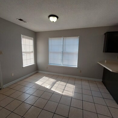 Unfurnished dining area with a textured ceiling an