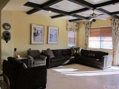 Beamed ceilings in the family room with raised hea